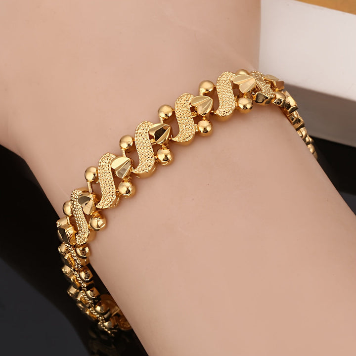 Pulsera ondulada flor de lis · Dorado