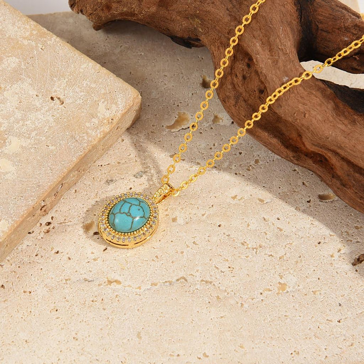 Collar Calysse con flor azul · Dorado