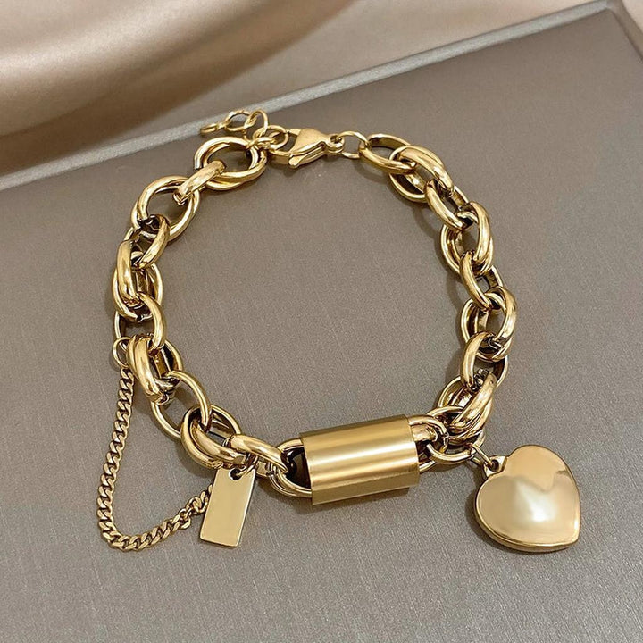 Pulsera gruesa con candado y corazón · Dorado o plateado