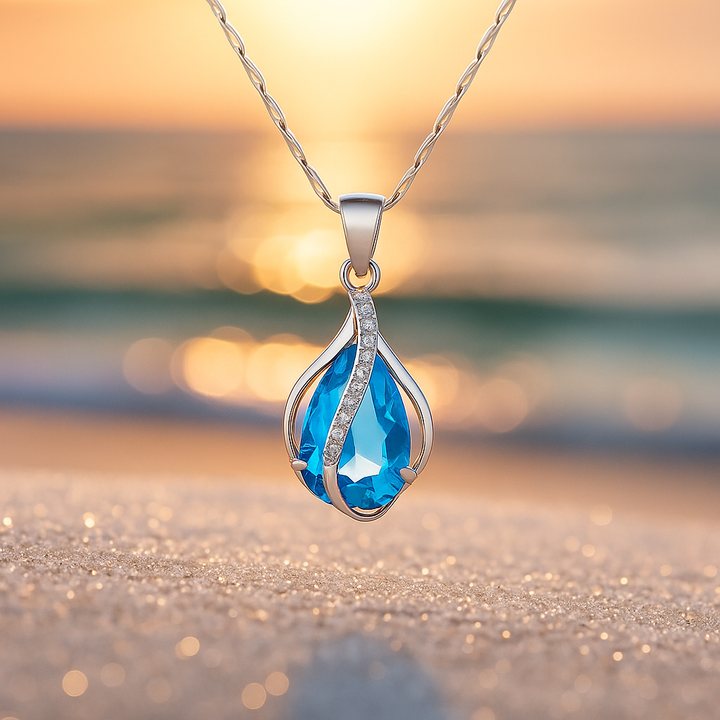 Collar con gota azul y línea de brillos · Plateado