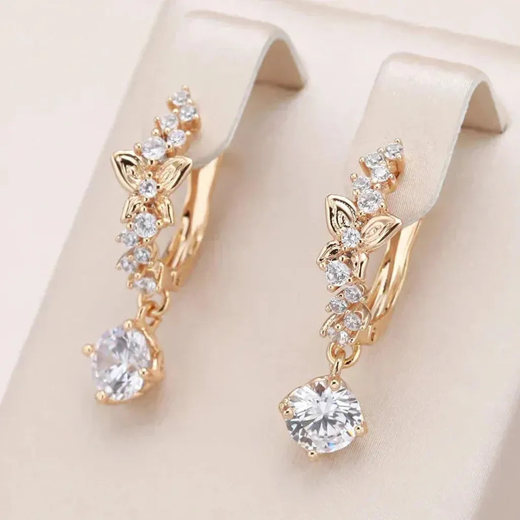 Pendientes colgantes con flor y brillo · Dorado