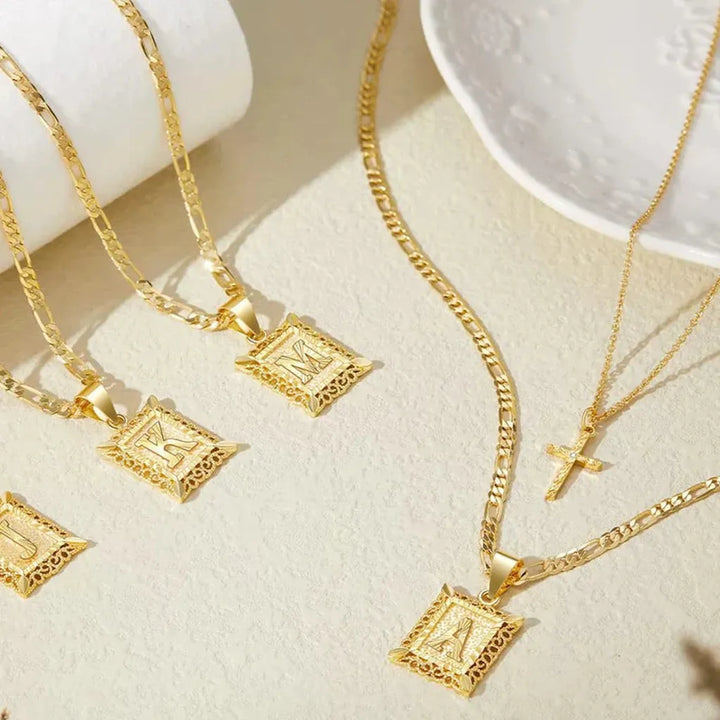 Collar doble con cruz e inicial · Dorado