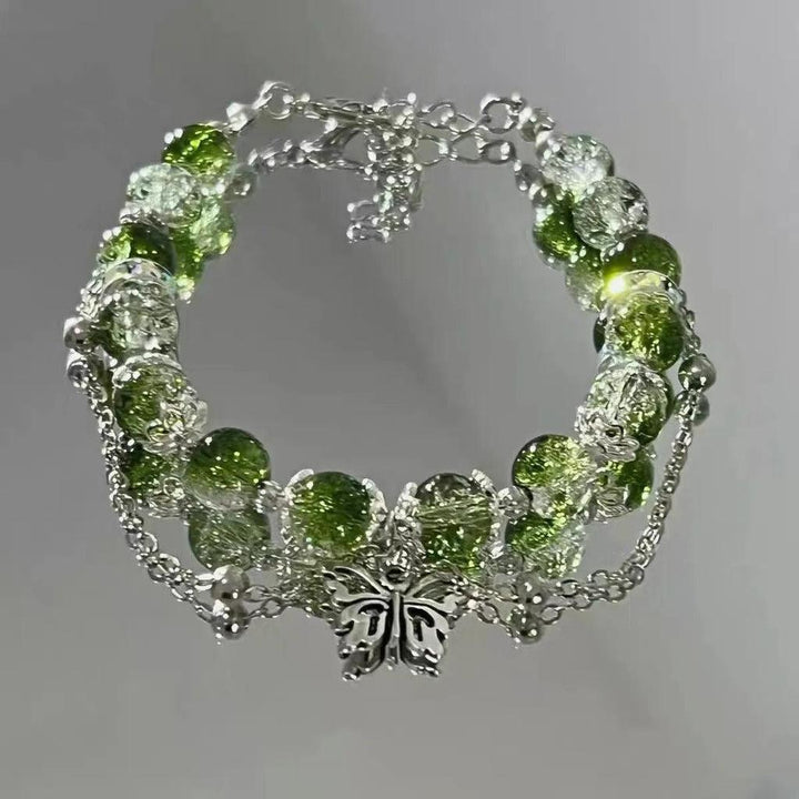 Pulsera retro con mariposa y cuentas verdes · Plateado