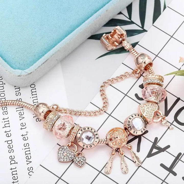 Pulsera de charms atrapasueños · Rosado