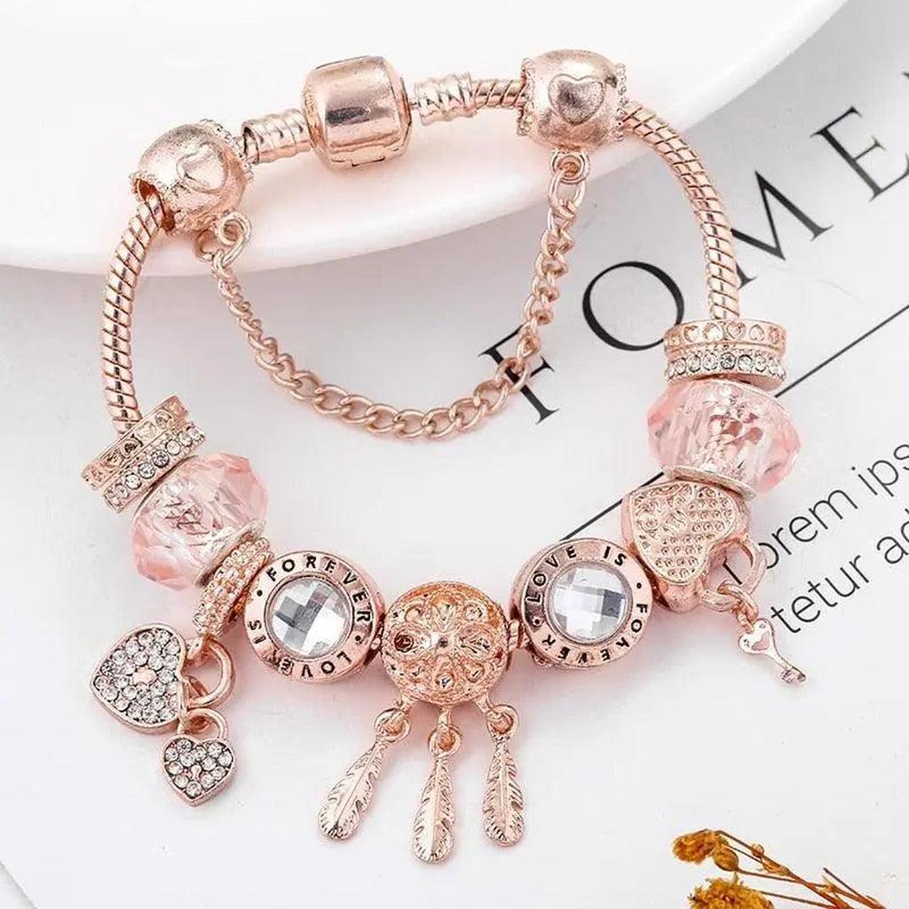 Pulsera de charms atrapasueños · Rosado