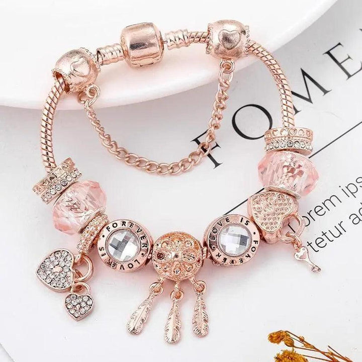 Pulsera de charms atrapasueños · Rosado