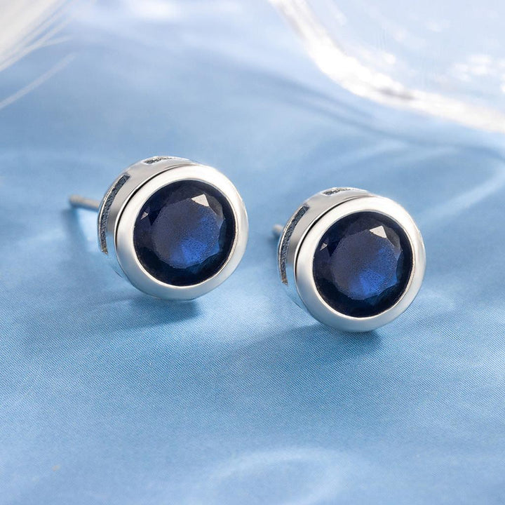 Pendientes de botón con detalle azul zafiro · Plateado