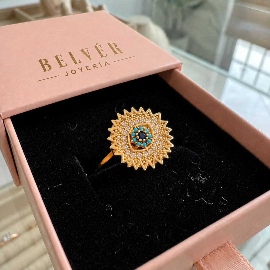 Anillo giratorio Rayos de sol azul zafiro · Dorado